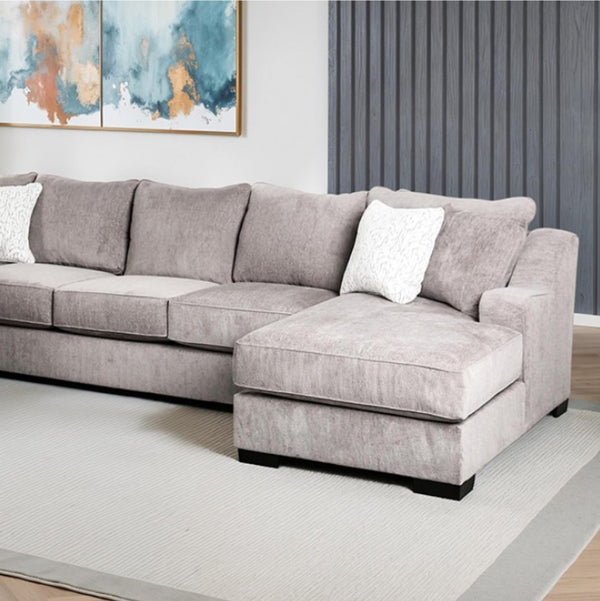 Mika Oversized Transitional Style Sectional Sofa Gray sectional sofa in a living room with abstract art on the wall.
