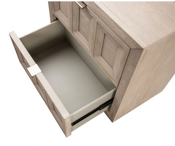 Montague Cross Modern Classic Tawny Credenza A close-up of a light wood drawer pulled open, showing a smooth light gray interior and a silver drawer pull handle on a white background.