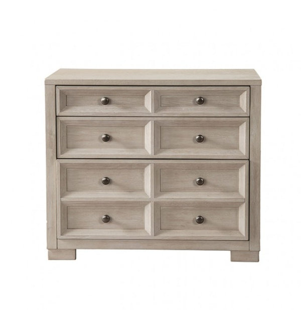 Montague Cross Modern Classic Tawny Credenza A six-drawer wooden chest of drawers in a light grayish-brown finish with small round dark metal knobs, shown against a plain white background.