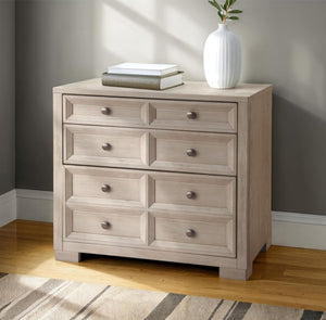 Montague Cross Modern Classic Tawny Credenza Light wood dresser with four drawers against a gray wall.