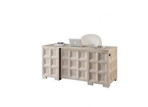 Montague Cross Modern Classic Tawny Executive Desk A light beige wood writing desk with a geometric paneled design, styled with a laptop, glasses, and a white chair on a plain white background.