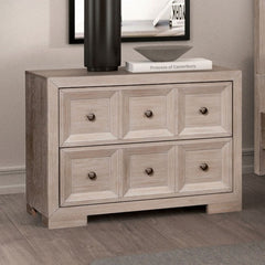 Montague Cross Modern Classic Tawny Oversized Nightstand A light gray wood dresser with six drawers and round dark knobs, shown in a styled room setting with a black vase, a book, and framed wall art on top.