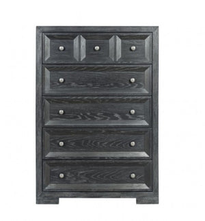 Montague Cross Modern Classic Weathered Black Chest A five-drawer chest of drawers in a distressed dark gray wood finish, featuring small round silver knobs and decorative panel details on the drawer fronts, shown against a plain white background.