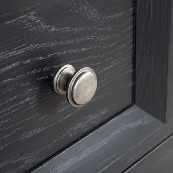 Montague Cross Modern Classic Weathered Black Chest Close-up of a silver door handle on a dark wooden door