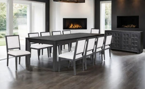 Montague Cross Modern Style Weathered Black Dining Server A modern dining room set featuring a dark gray rectangular dining table and eight matching chairs with white upholstered seats, shown in a contemporary dining room with wood floors and built-in fireplaces.
