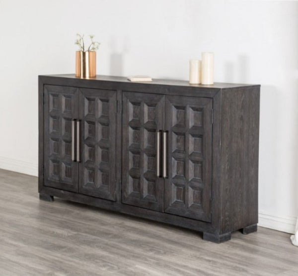 Montague Cross Modern Style Weathered Black Dining Server A dark charcoal gray wooden sideboard cabinet with four decorative paneled doors and vertical metal handles, styled in a room with gray wood flooring and a white wall.