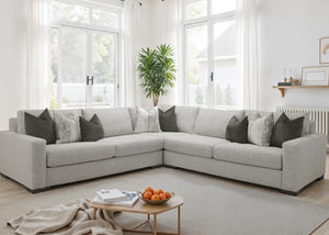 Nareen Gray Fabric Sectional Sofa with Multicolor Pillows Modern living room with a gray sectional sofa, coffee table, and decorative items.