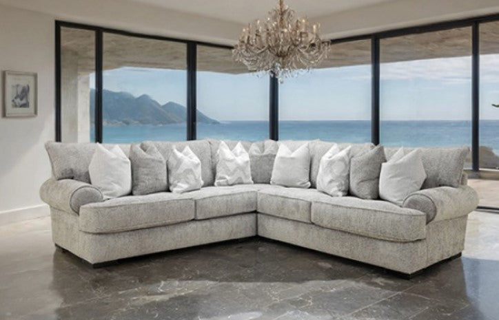 Nareen Gray Fabric Sectional Sofa with Pillows Gray sectional sofa with white pillows in a room with large windows overlooking an ocean view.