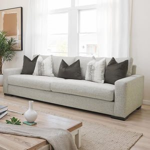Nareen Gray Fabric Sofa with Multicolor Pillows Light gray sofa with decorative pillows in a bright living room.