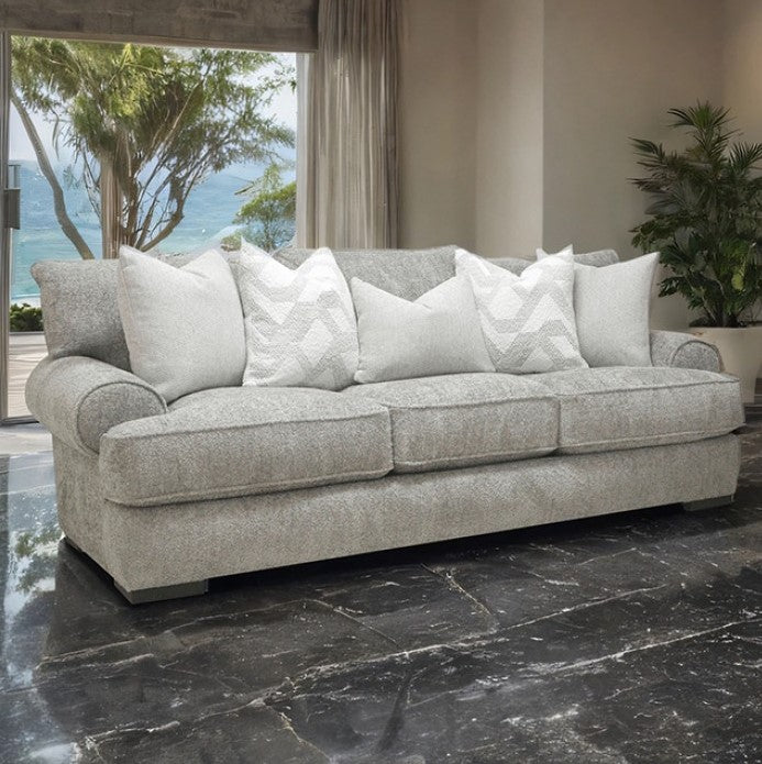Nareen Gray Fabric Sofa with Pillows Gray sofa with white pillows in a living room with a view of the ocean.