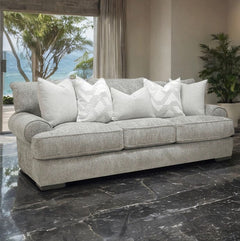 Nareen Gray Fabric Sofa with Pillows Gray sofa with white pillows in a living room with a view of the ocean.