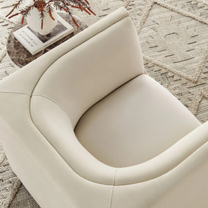Natalia Alabaster Velvet Fabric Chair Beige armchair on a textured rug with a small table and decorative items.
