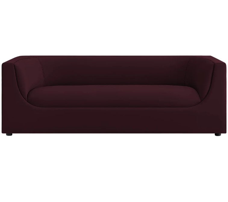 Natalia Mulberry Velvet Fabric Sofa Maroon sofa in a living room with a painting on the wall and a lamp.