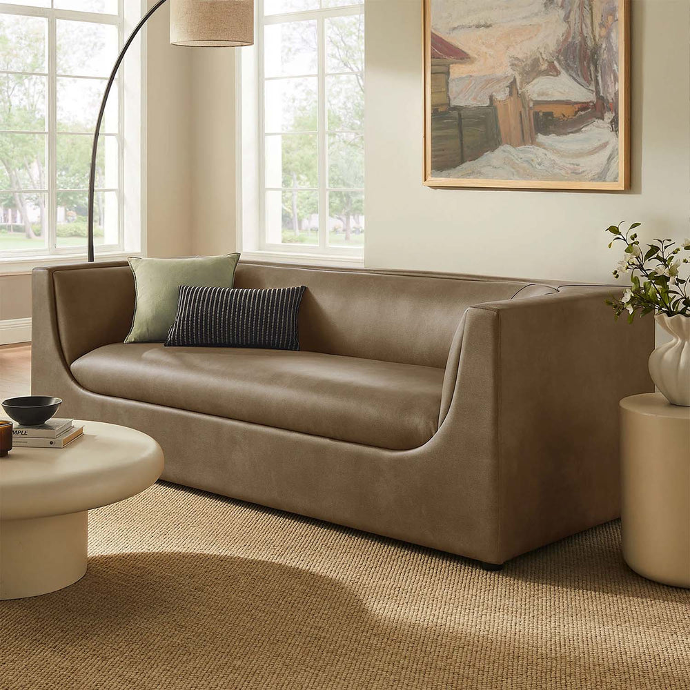 Natalia Premium Vegan Leather Sofa Beige sofa in a living room with a painting on the wall and a lamp.