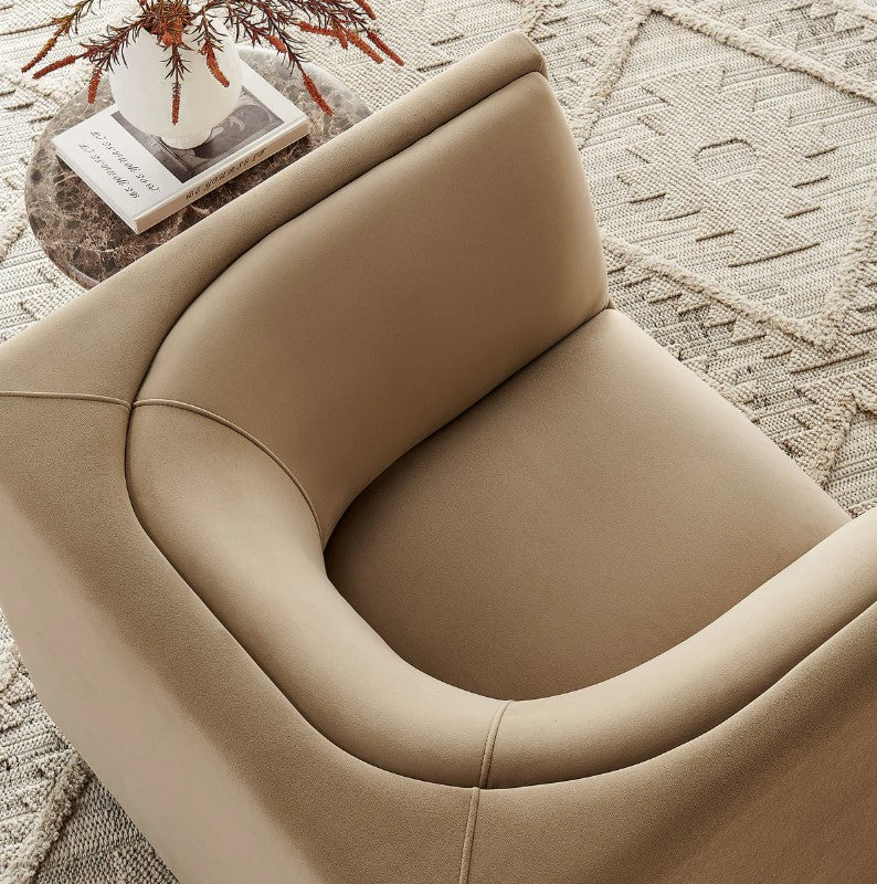 Natalia Taupe Velvet Fabric Chair Beige armchair in a room with a large window view of greenery