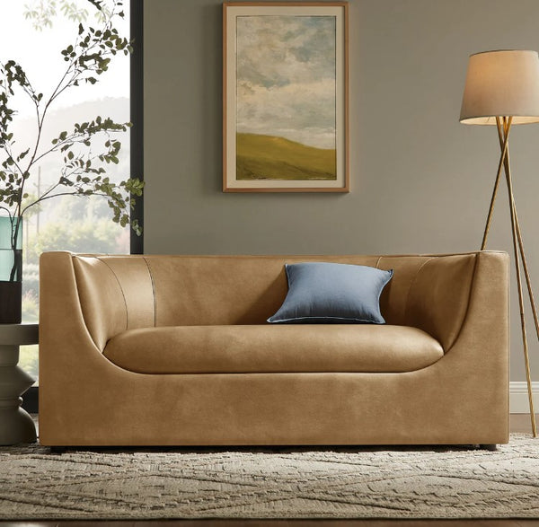 Natalia Toast Premium Vegan Leather Loveseat Brown leather sofa with a blue pillow in a living room setting.