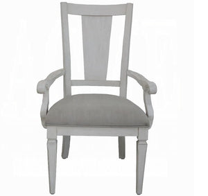 A light gray upholstered armchair with a tall slatted backrest and turned legs, shown against a plain white background.