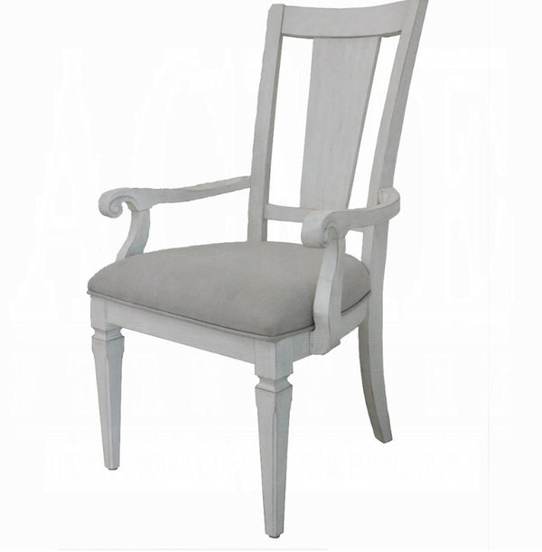 A light gray painted wooden dining chair with a high slatted backrest, rolled arms, and a matching upholstered seat cushion, shown on a plain white background.
