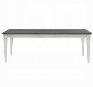 A rectangular dining table with a dark gray wood-look top and a white painted frame and legs, shown against a plain white background.