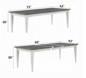 A white wooden dining table with a dark gray rectangular tabletop, shown in two configurations with dimension labels indicating 72 by 42 inches and 90 by 42 inches on a white background.