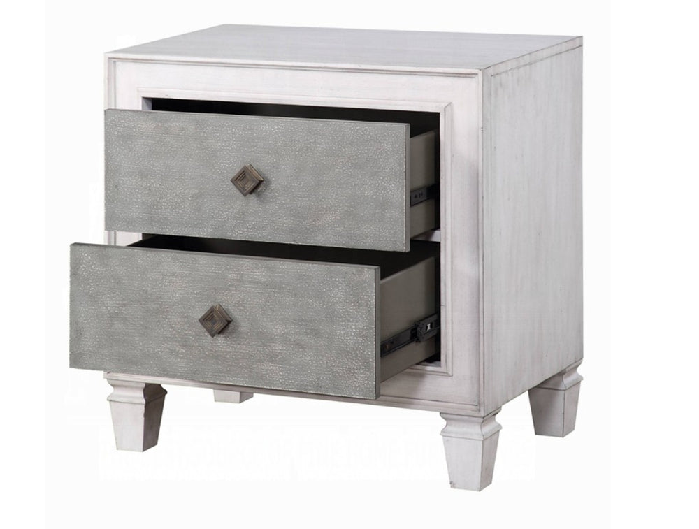 Natasha Two Tone Light Gray Nightstand A white two-drawer nightstand with textured gray drawer fronts and small dark diamond-shaped pulls, styled in a bedroom setting with a table lamp, books, and flowers on top.