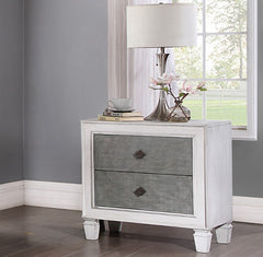 Natasha Two Tone Light Gray Nightstand A white two-drawer nightstand with textured gray drawer fronts and small dark diamond-shaped pulls, styled in a bedroom setting with a table lamp, books, and flowers on top.