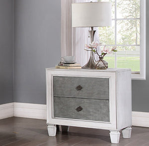 Natasha Two Tone Light Gray Nightstand A white two-drawer nightstand with textured gray drawer fronts and small dark diamond-shaped pulls, styled in a bedroom setting with a table lamp, books, and flowers on top.