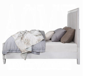 Natasha Upholstered Light Gray Linen Bedroom A light gray wooden bed frame with a tall panel headboard and matching footboard, styled with gray bedding, patterned throw blankets, and neutral pillows on a white background.