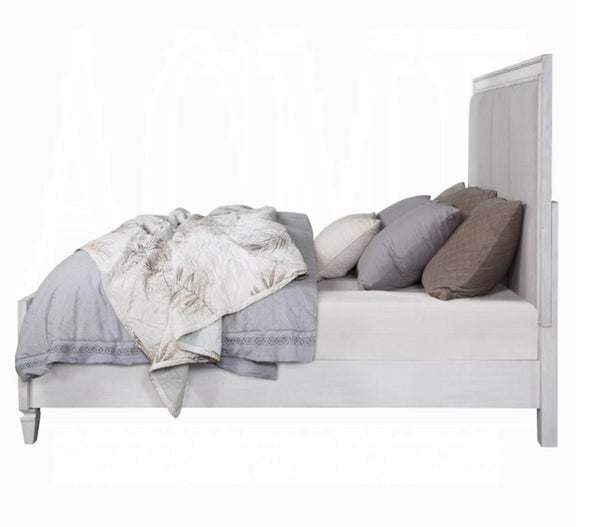 Natasha Upholstered Light Gray Linen Bedroom A light gray wooden bed frame with a tall panel headboard and matching footboard, styled with gray bedding, patterned throw blankets, and neutral pillows on a white background.
