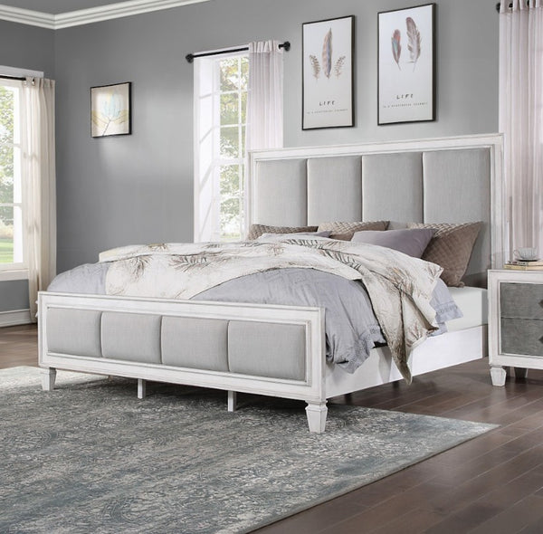 Natasha Upholstered Light Gray Linen Bedroom A white upholstered bed frame with a tall segmented headboard and matching footboard, styled in a bedroom with gray walls, neutral bedding, and a patterned area rug.