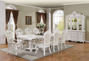 White dining set with chairs and a table in a room with a large window and decorative elements.