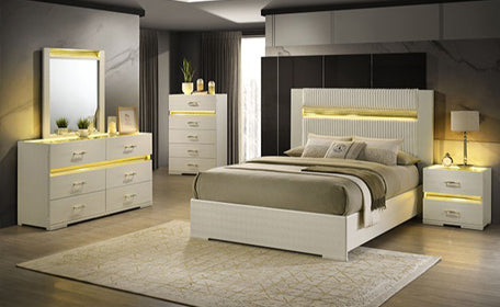 Modern bedroom set with white furniture, including bed, dresser, and nightstands, in a well-lit room.