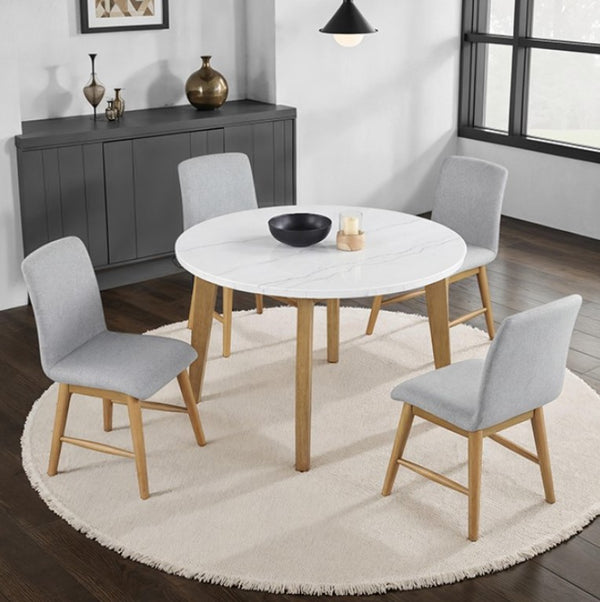 Nolan Genuine Marble Top Round Dining Table Dining room with a round white table and gray chairs on a wooden floor.