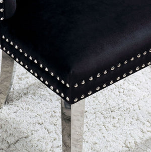Noonwit Chrome Black Flannelette Fabric Chair (2/PK) Close-up of a black upholstered chair corner with silver nailhead trim and a metallic leg, set on a white shag rug.
