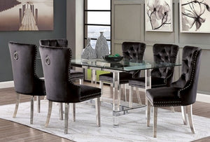 Noonwit Chrome Black Flannelette Fabric Chair (2/PK) A 7-piece dining room set featuring a rectangular glass-top table with a chrome metal frame and six black tufted velvet chairs with silver nailhead trim and ring pulls, shown in a modern dining room setting.