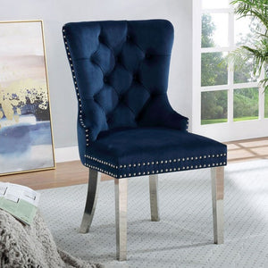Noonwit Chrome Blue Flannelette Fabric Chair (2/PK) A navy blue velvet dining chair with a high button-tufted back, silver nailhead trim, and curved metallic legs, shown in a bright modern room setting.