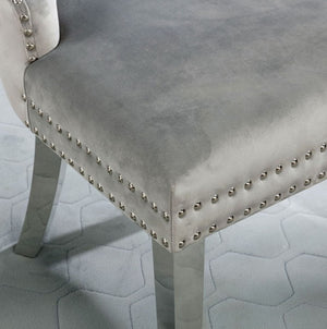 Noonwit Chrome Silver Flannelette Fabric Chair Gray velvet chair with nailhead trim on a light gray floor.