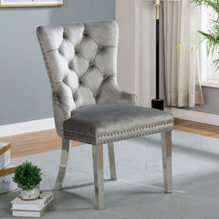 Noonwit Chrome Silver Flannelette Fabric Chair A high-back dining chair upholstered in light gray tufted velvet with silver nailhead trim and slim metallic legs, shown in a styled room setting with a gray wall, curtains, and a small plant.
