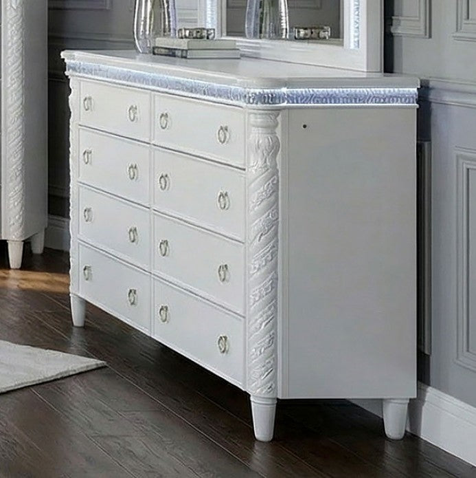 Octavia Victorian Style Pearl White Mirror Decorative mirror with white frame on a gray wall with two clear vases holding white flowers.