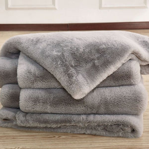 Patricia Power Loomed Modern Silver Area Rug Material  Stack of gray plush blankets on a wooden surface