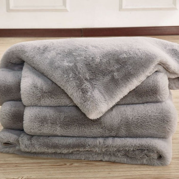 Patricia Power Loomed Modern Silver Area Rug Material  Stack of gray plush blankets on a wooden surface