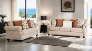 Two beige sofas with patterned cushions in a living room setting.