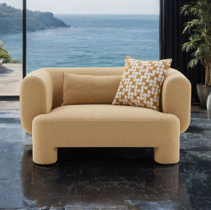 Phillip Modern Tight Seat Chair with Pillows Beige sofa with a patterned pillow in a room with a large window view of the ocean.