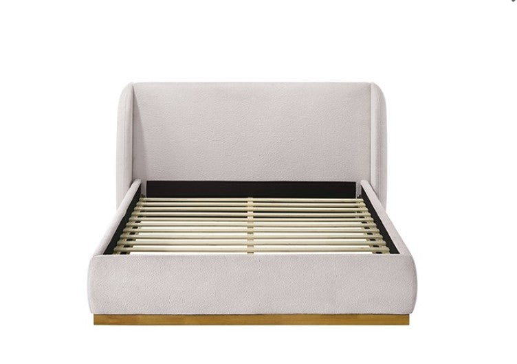 Pirewin Boucle Fully Upholstered Wingback Gold Plinth Base Bed White upholstered bed with wooden base in a room setting.