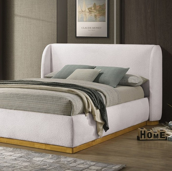 Pirewin Boucle Fully Upholstered Wingback Gold Plinth Base Bed White upholstered bed with wooden base in a room setting.
