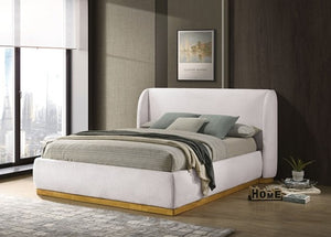 Pirewin Boucle Fully Upholstered Wingback Gold Plinth Base Bed Modern bedroom with a white upholstered bed, gray bedding, and a cityscape view.