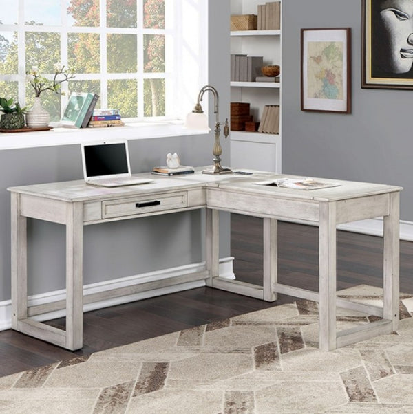 Prigala Antique White L-Shaped Corner Desk with USB Power Outlet An L-shaped corner desk in a distressed white or light gray wood finish, styled in a home office setting with a laptop, lamp, and books.