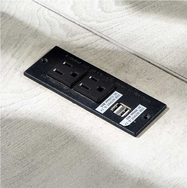 Prigala Antique White L-Shaped Corner Desk with USB Power Outlet Black electrical outlet panel with two sockets and a USB port on a light wooden surface.