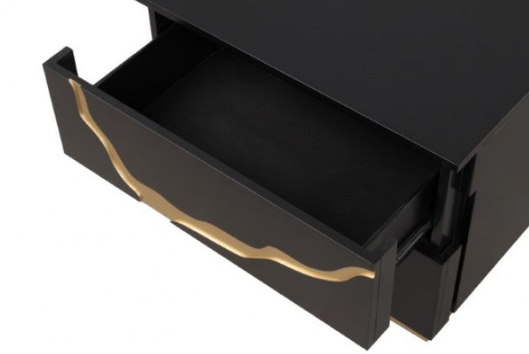 Primeberg Modern Black Gold Pattern Nightstand A modern two-drawer nightstand in glossy black with a bold gold abstract branch-like inlay and a gold base, shown beside a bed in a styled bedroom setting.