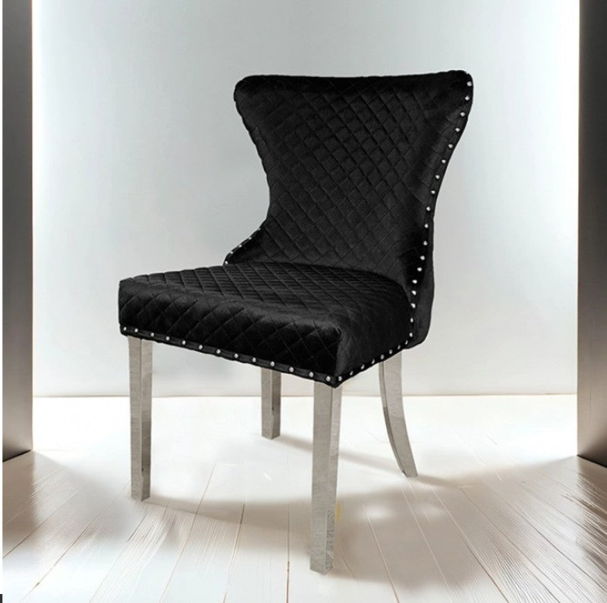 Primenova Upholstered Silver Black Dining Chair Black quilted chair with silver legs on a white floor and light gray walls